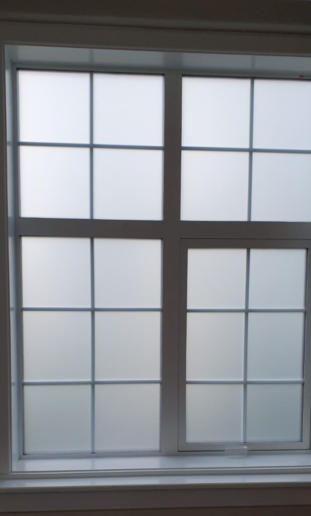 Installation of 3M frosted film to multiple windows of this size throughout the building for privacy